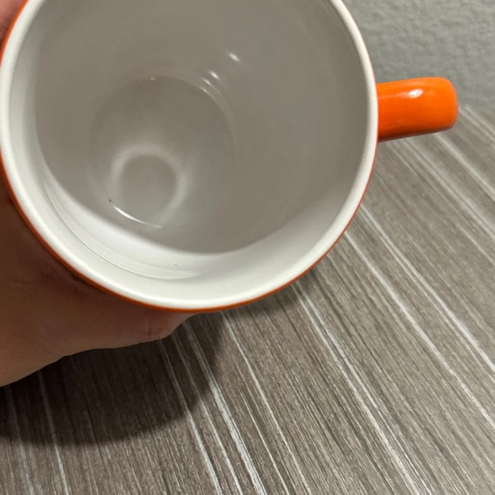 Orange Mug with Black Mustache Design